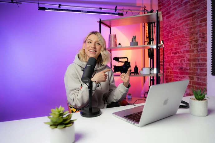 a woman sitting in front of a laptop computer